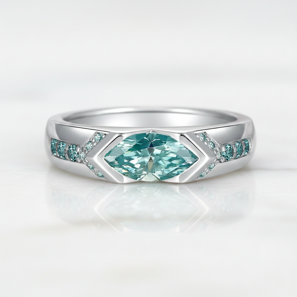A silver-toned ring featuring a marquise-cut light blue gemstone in the center, flanked by small pavé-set light blue stones on a white background.