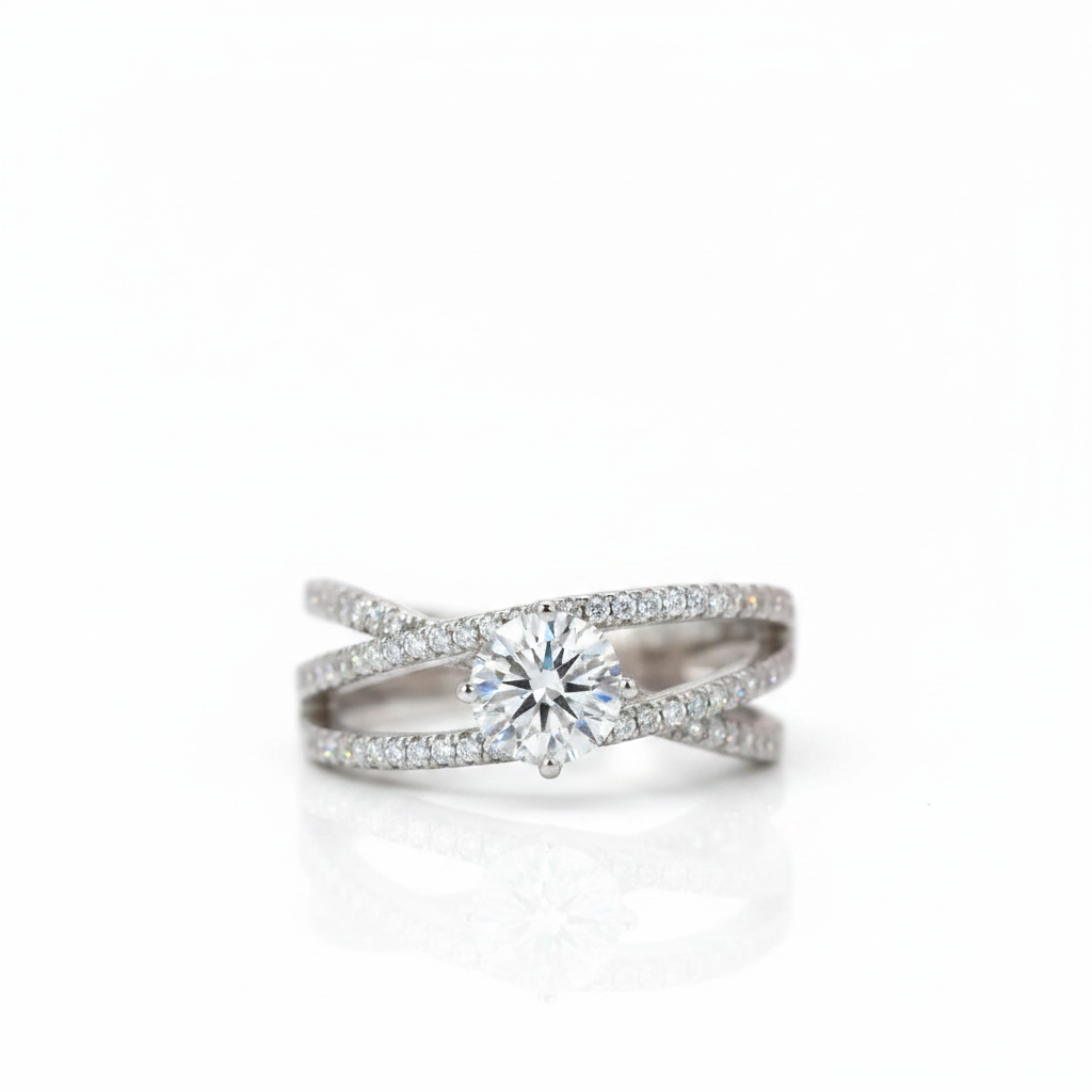 A silver-tone double-band engagement ring featuring a round-cut center stone and pavé-set accent stones, shown on a clean white background with a soft reflection.