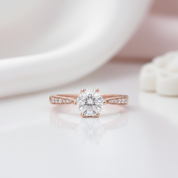 Rose gold ring with a diamond on a soft white background