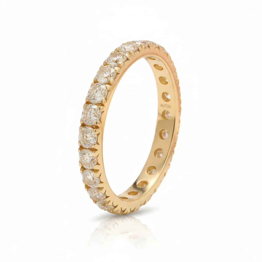 A yellow gold eternity ring featuring a half-channel setting of round brilliant-cut diamonds on a clean white background with a soft reflection.