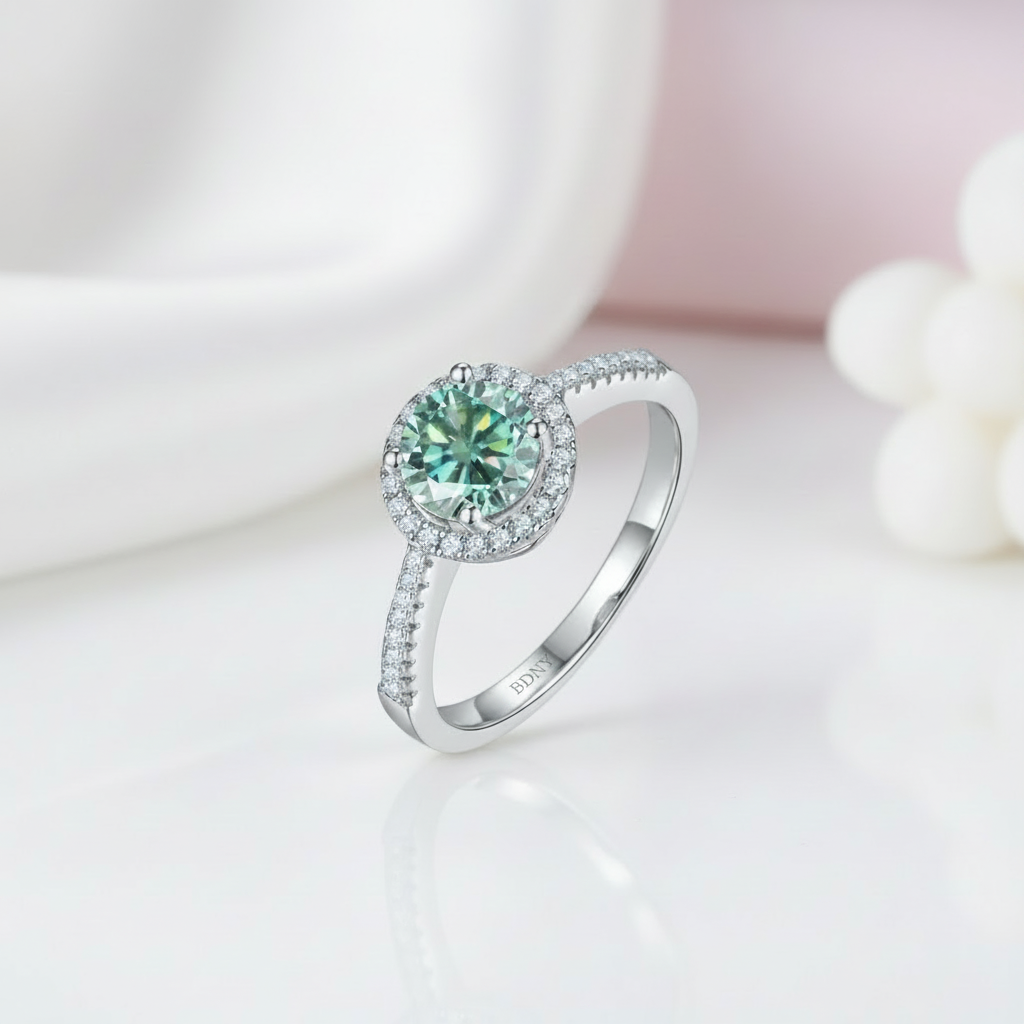 Silver ring with a green gemstone on a soft background