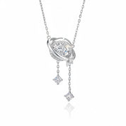A silver-toned space-themed pendant necklace featuring a ring with a central clear gemstone, a small moon, and two dangling star charms, shown on a clean white background with a soft reflection.