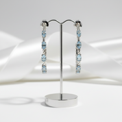 2.94 Ctw Oval Sky Blue Topaz Hoop Earrings-Black Diamonds New York
