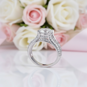Silver ring with a diamond in front of pink and white roses