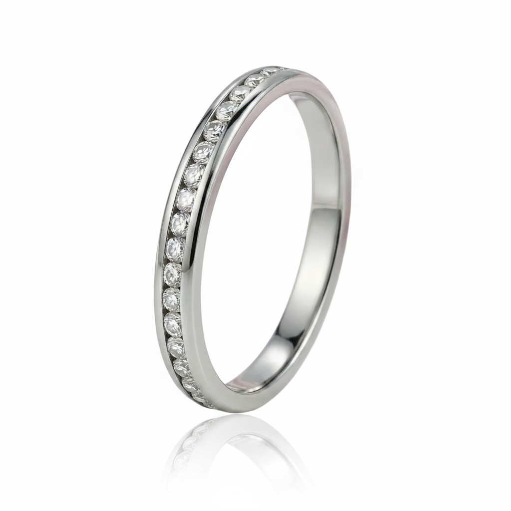 A polished silver-tone eternity band ring featuring a channel-set row of clear round-cut stones on a seamless white background with a soft reflection.
