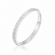 A silver eternity ring featuring a single row of round-cut clear gemstones, shown on a clean white background with a soft reflection. The inside of the band is engraved with 'BLACK DIAMONDS NEW YORK'.