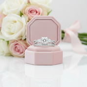 Diamond ring in a pink box with flowers in the background