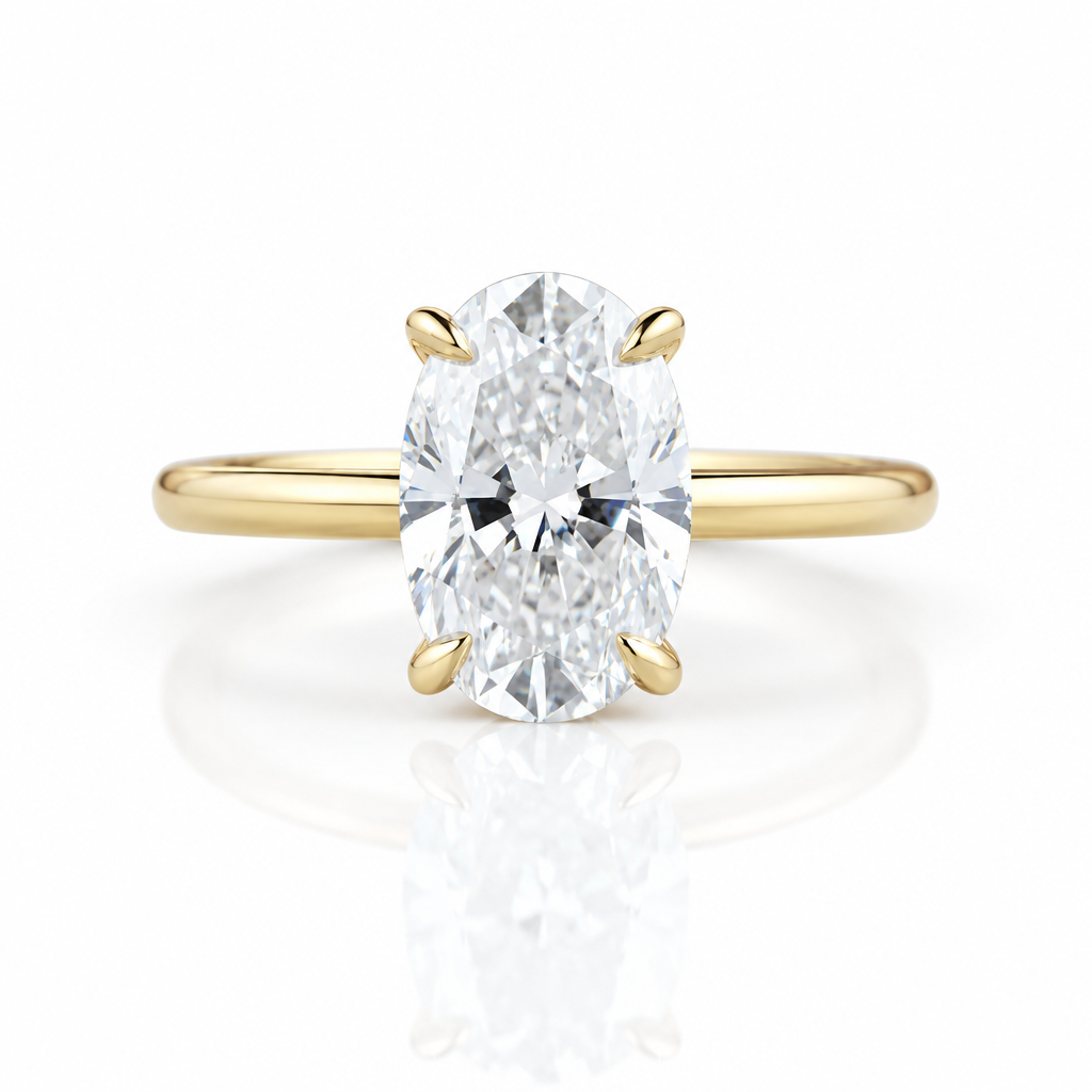 An oval diamond engagement ring with a yellow gold band, featuring a brilliant-cut center stone in a four-prong setting on a clean white background with a soft reflection below.