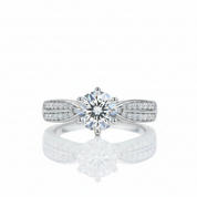 A silver-tone solitaire engagement ring with a round-cut center stone and pavé-set side stones, shown on a clean white background with a soft reflection below.