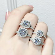 Four diamond rings on a hand against a light background