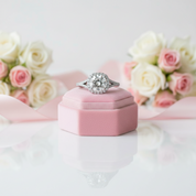 Diamond ring in a pink box with flowers in the background