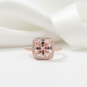 Rose gold ring with a large pink gemstone on a white background