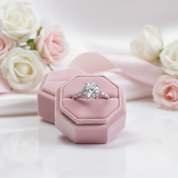 Diamond ring in a pink hexagonal box with flowers in the background