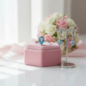 Silver ring and earrings with blue gemstones on a white background