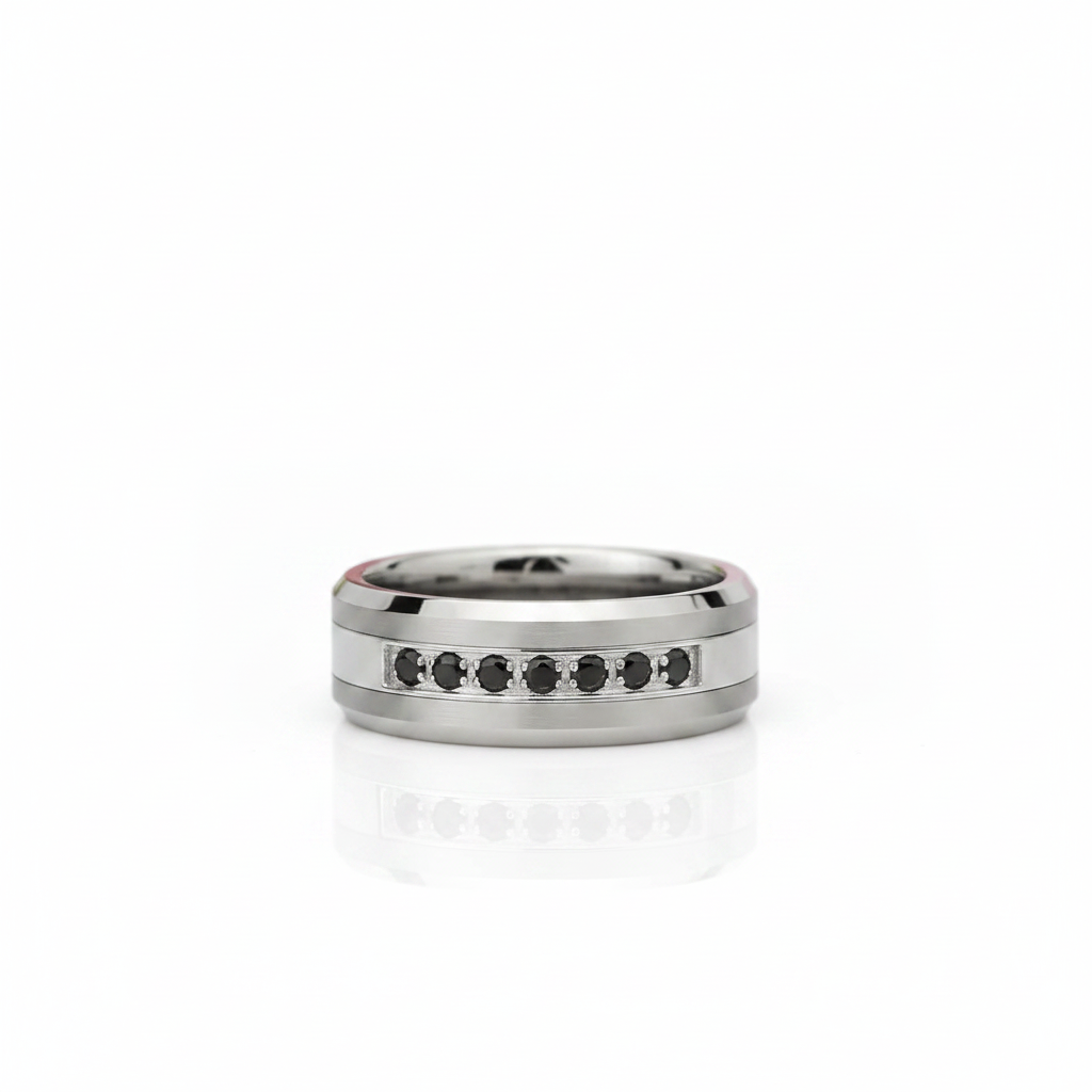 A silver-toned band ring with a row of small black round stones set along the front, photographed on a clean white background with a soft reflection below.