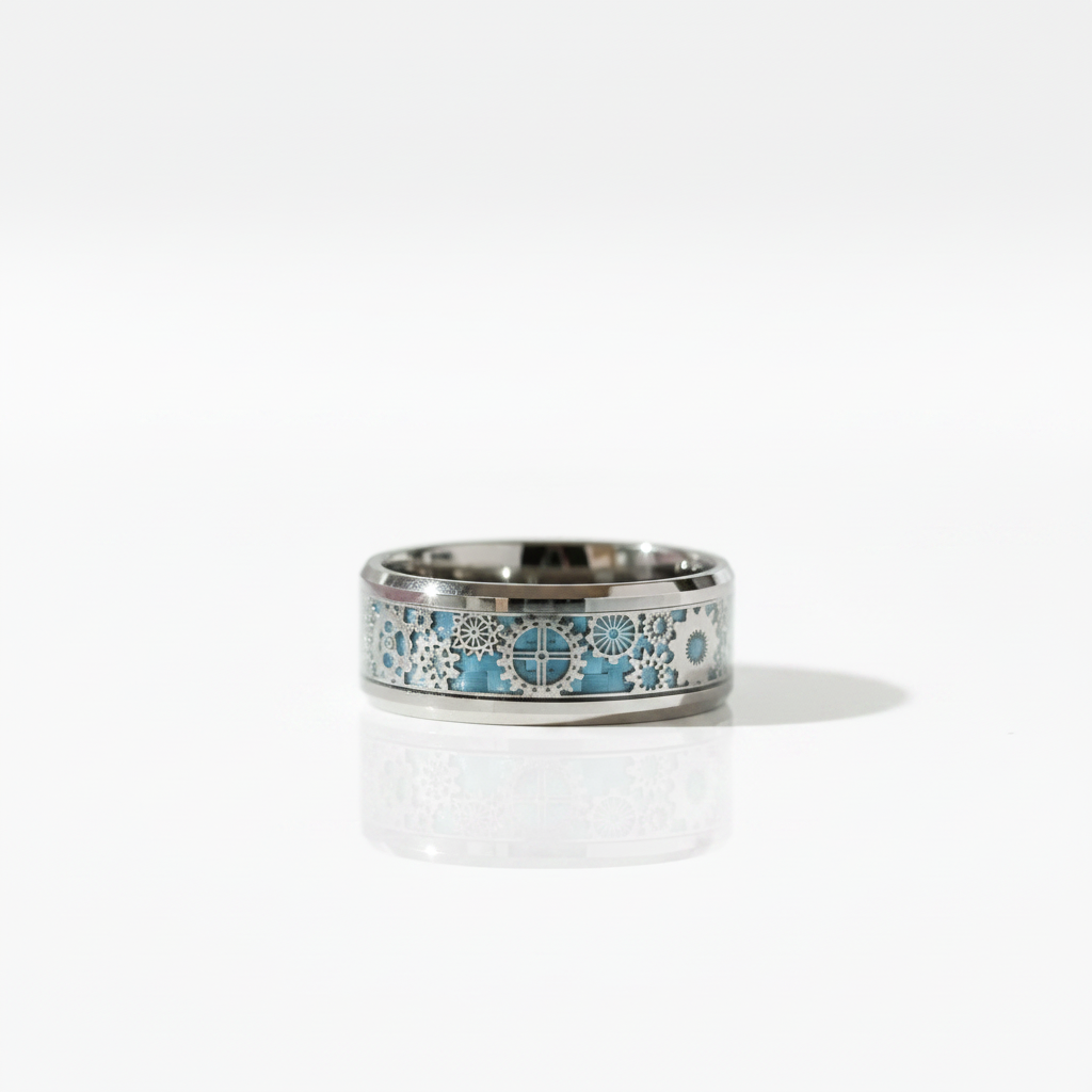 A polished silver-toned band ring featuring an intricate inlay of light blue, white, and gray floral and geometric patterns, displayed on a clean white reflective surface.