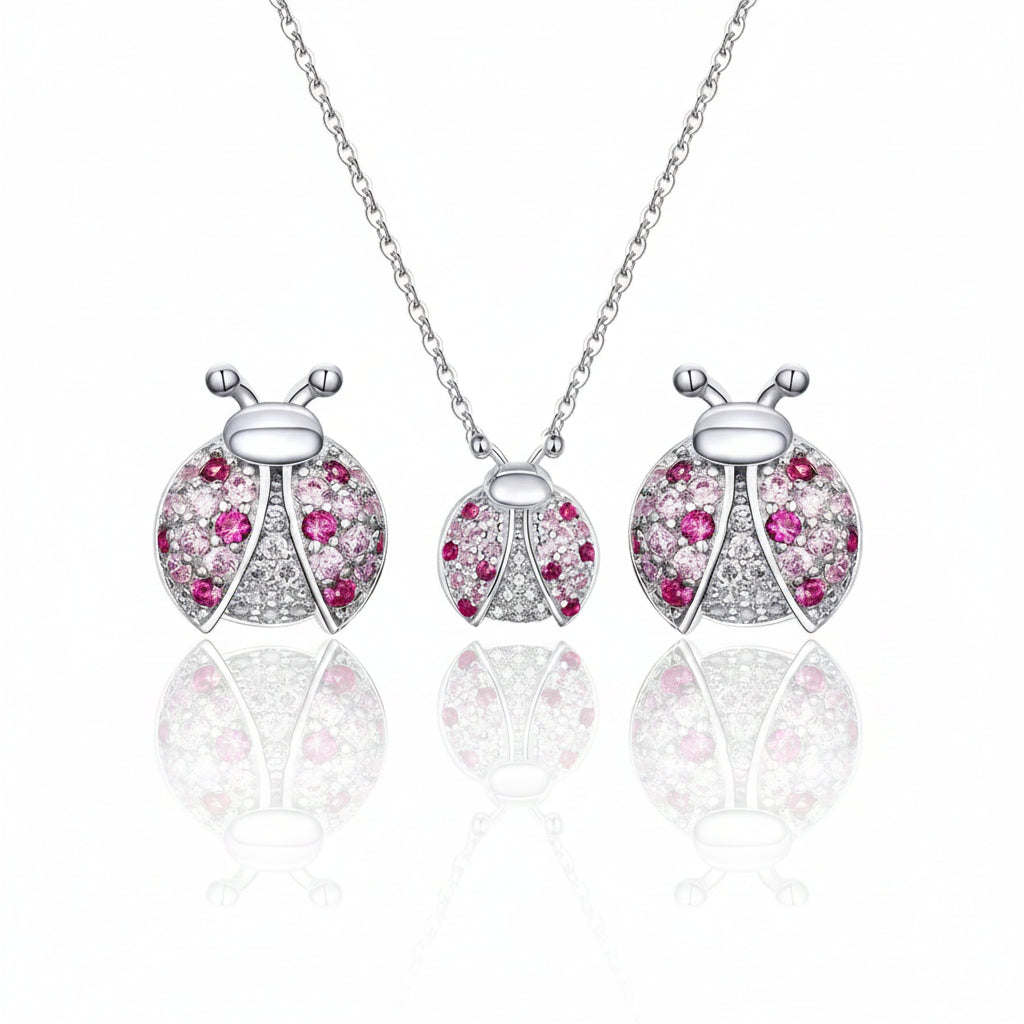 Sterling silver ladybug pendant necklace and matching earrings set, featuring pink and clear stones on a white background with a 925 silver stamp.