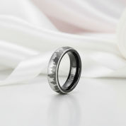 Silver ring with nature design on a white fabric background