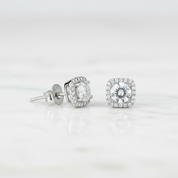 Silver stud earrings with clear gemstones on a light gray background