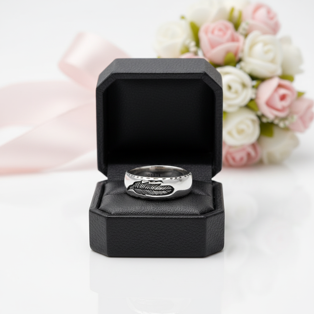 Silver ring in a black box with flowers in the background