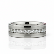A silver-toned band ring featuring a channel-set row of round clear gemstones along the top edge, photographed on a clean white background with a soft reflection below.