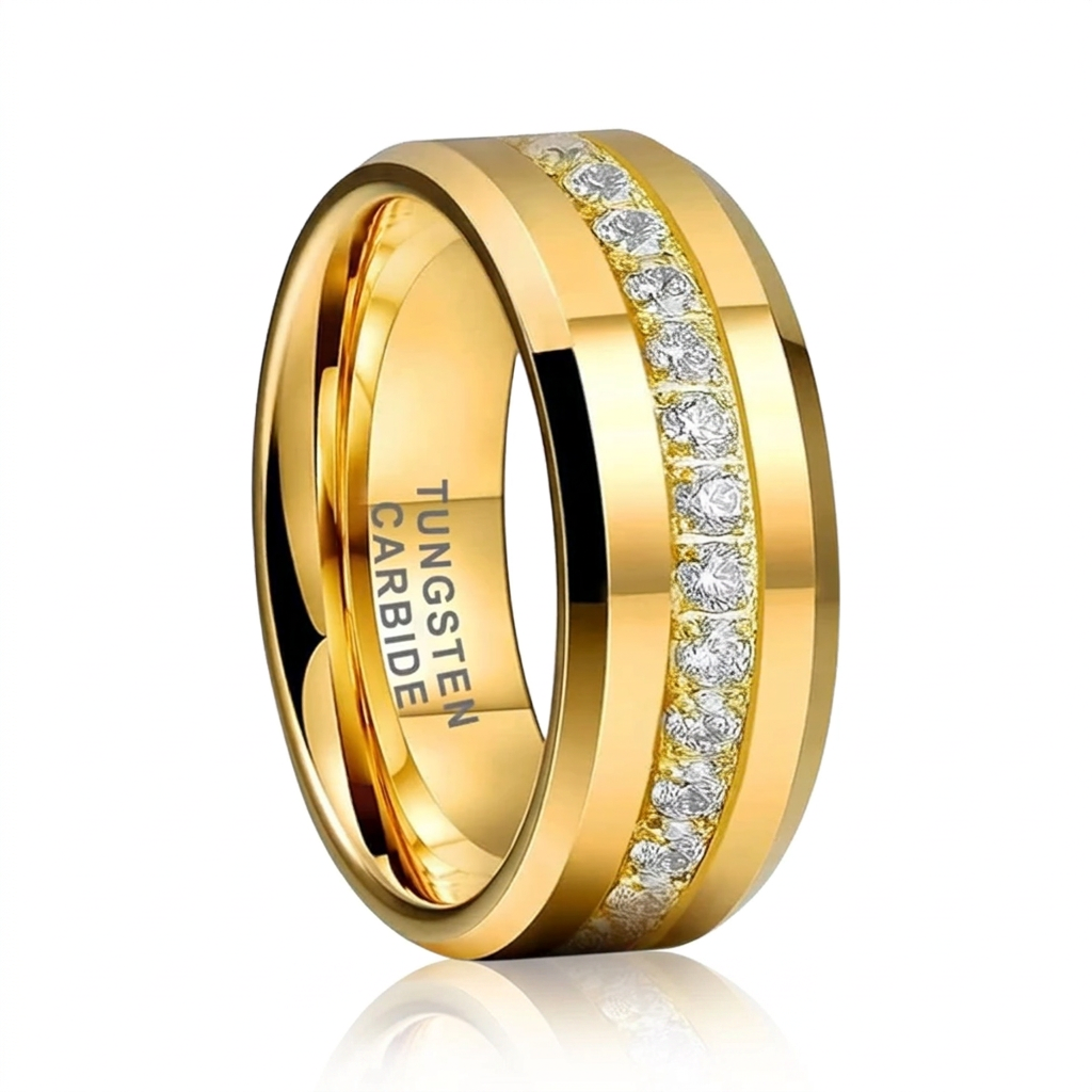 A polished yellow gold wedding band ring featuring a channel-set row of round-cut clear stones on one side, with 'TUNGSTEN CARBIDE' engraved on the inside, shown on a white background with a soft reflection.