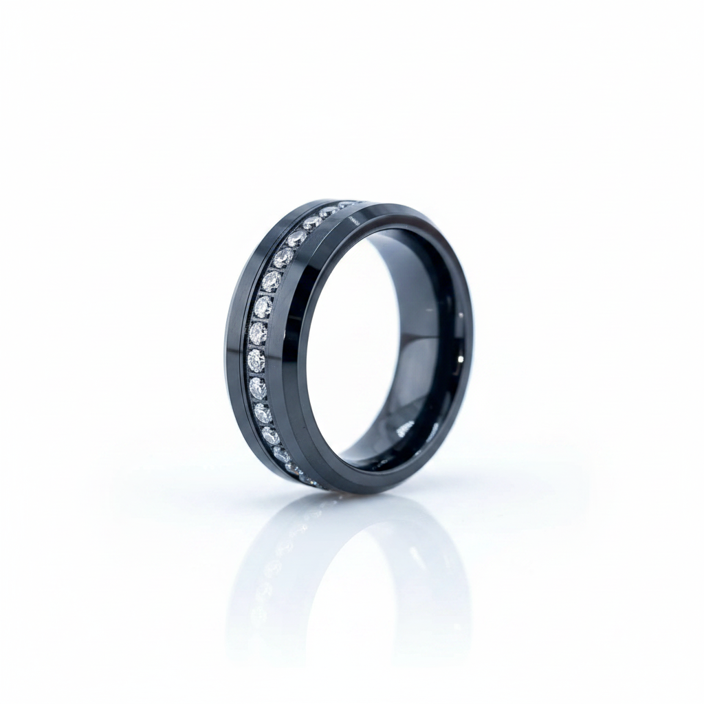 A black ceramic ring band featuring a channel-set row of clear cubic zirconia stones, displayed on a clean white reflective surface.