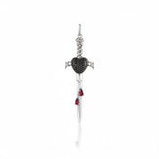 A silver dagger pendant featuring a black heart-shaped center, accented with two small red teardrop gemstones near the blade, shown on a clean white background with a soft reflection.