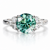 A silver-tone ring featuring a large round brilliant-cut emerald green center stone, flanked by two small clear accent diamonds on each side, set against a clean white background with a soft reflection.