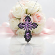 Purple floral pendant necklace with flowers in the background