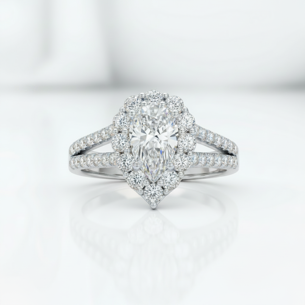 A pear-cut halo engagement ring in white metal with pavé-set diamonds, centered on a clean white reflective surface.