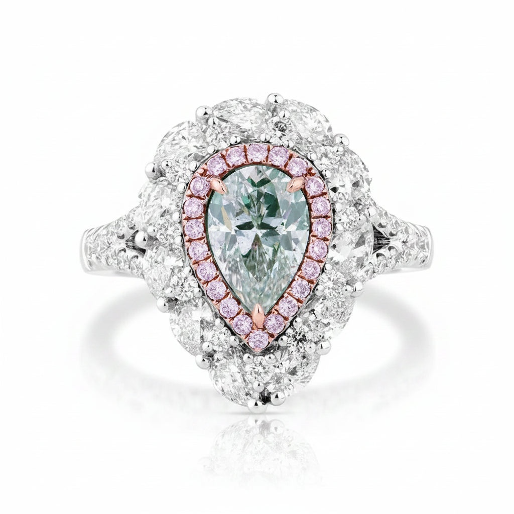 A pear-cut diamond ring with a halo of small pink diamonds and a white gold or platinum setting, photographed on a clean white background.