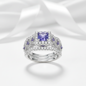 Elegant ring with a purple gemstone on a white background