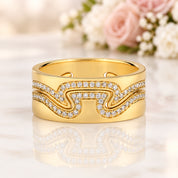 A gold-plated wavy band ring with pavé-set clear stones, shown on a white background with a Minty Box logo in the top-left corner.