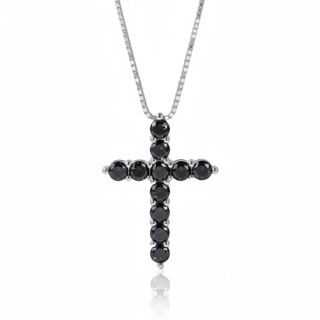A silver cross pendant necklace featuring round black gemstones, suspended from a silver chain on a clean white background.