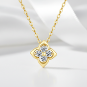 Gold necklace with a diamond pendant on a light background