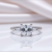 Silver ring with a large diamond on a white background