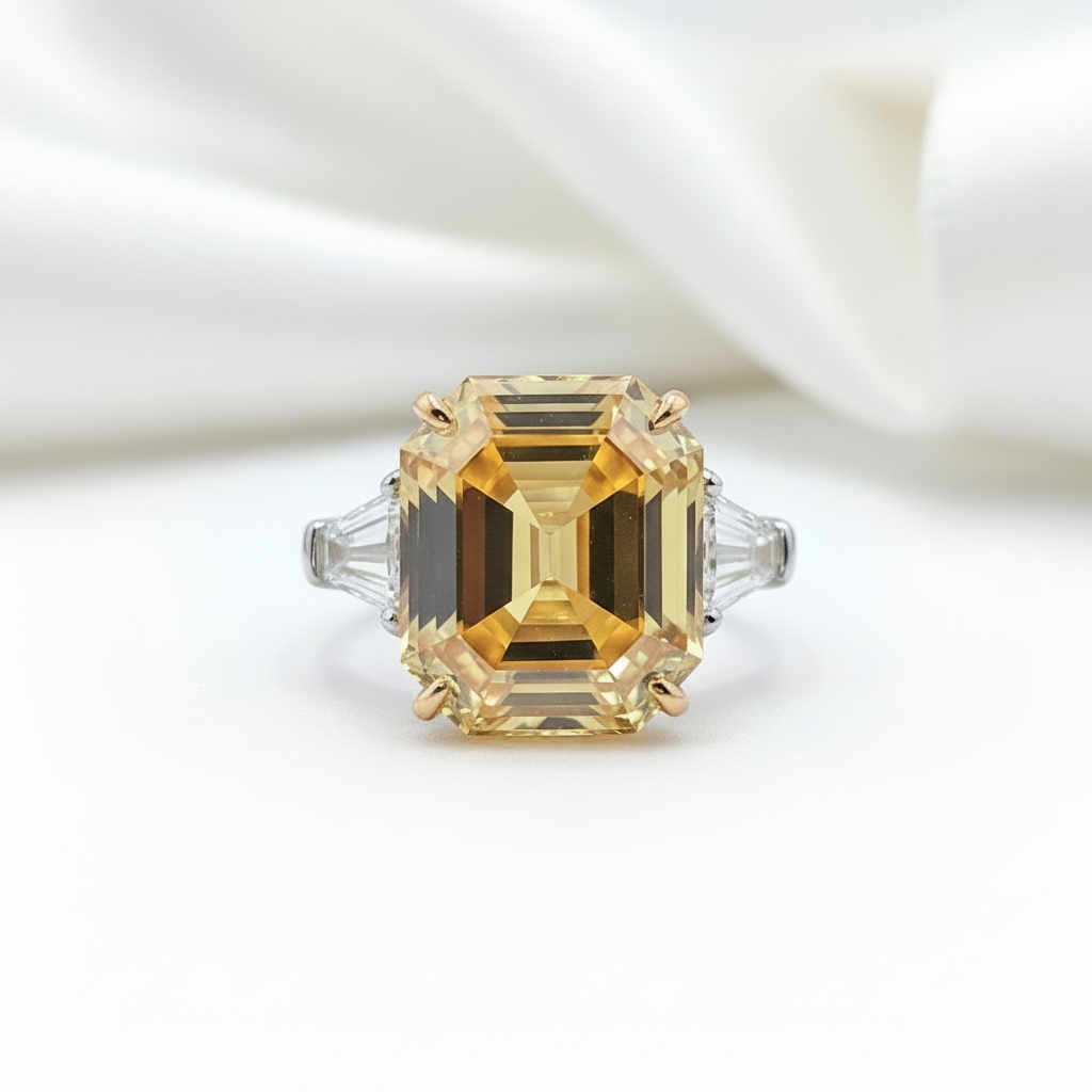 Ring with a large rectangular yellow gemstone on a white background