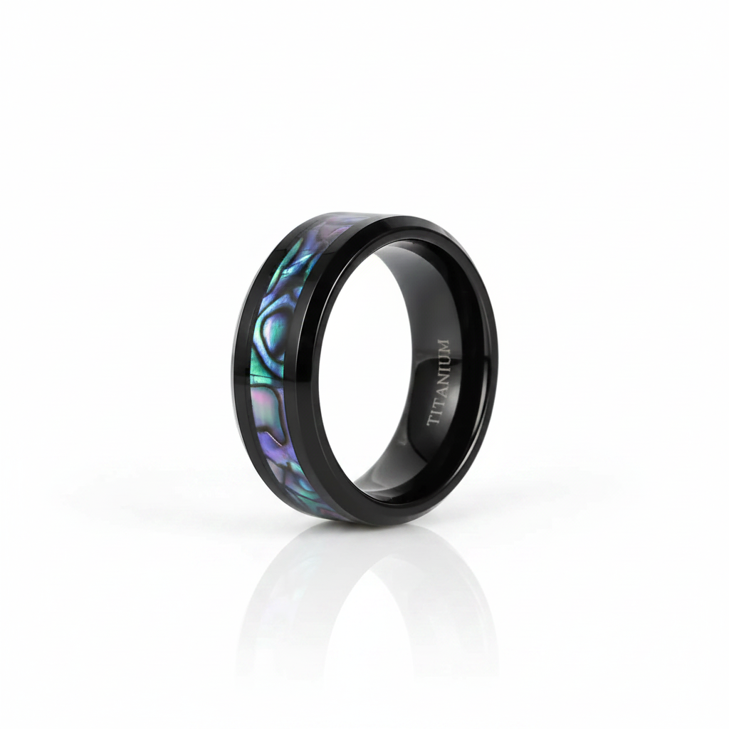 A black titanium ring with an iridescent abalone shell inlay, shown on a clean white background with a soft reflection.