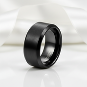 Black tungsten carbide ring on a white background
