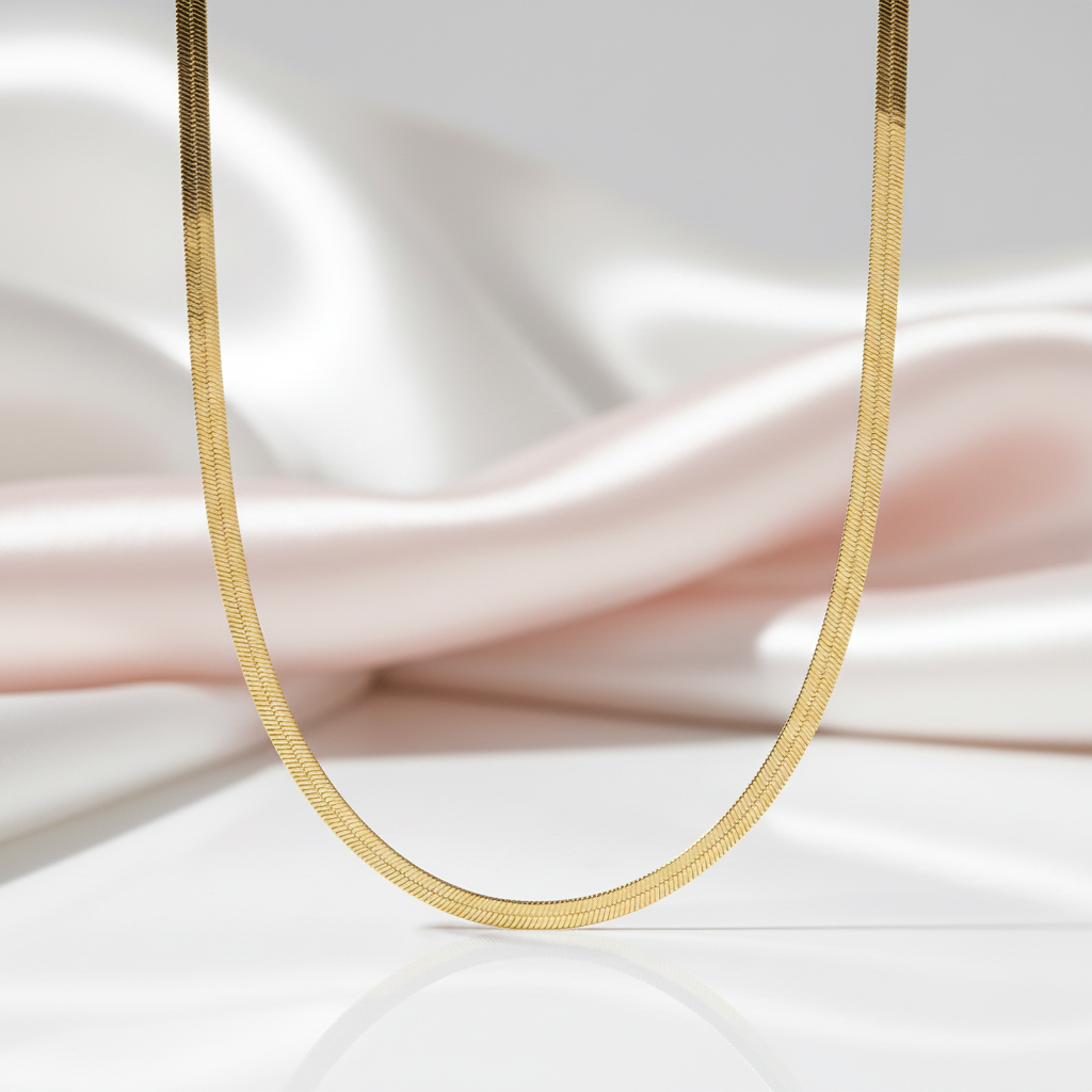 Gold necklace on a soft fabric background