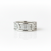 A silver-toned diamond ring with a modern interlocking design, featuring rows of clear pavé diamonds on a clean white background with a soft reflection.