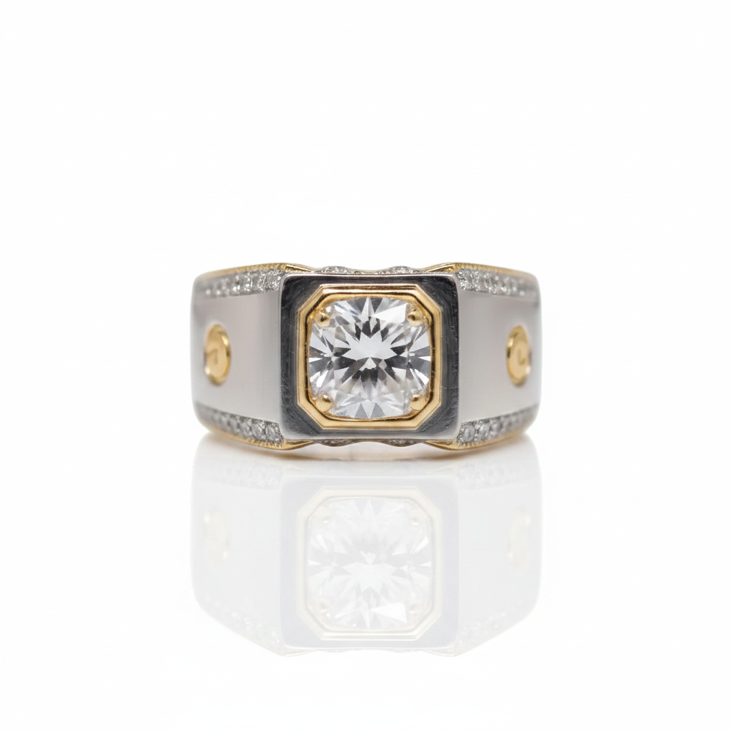 A two-tone diamond ring with a central round-cut diamond set in a gold-toned octagonal bezel, flanked by a white enamel inlay and a silver-toned band accented with small diamonds.