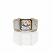 A two-tone diamond ring with a central round-cut diamond set in a gold-toned octagonal bezel, flanked by a white enamel inlay and a silver-toned band accented with small diamonds.