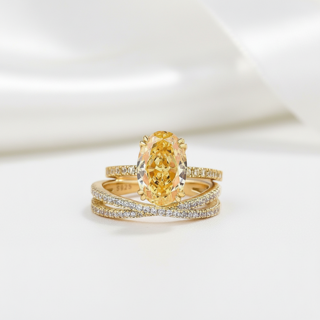 Gold ring with a large yellow gemstone on a white background