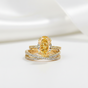 Gold ring with a large yellow gemstone on a white background