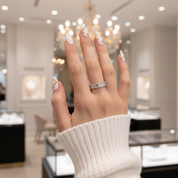 Hand with a ring in a blurred indoor setting