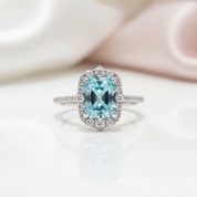 Silver ring with a blue gemstone on a white background