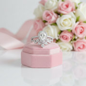 Diamond ring on a pink velvet box with flowers in the background