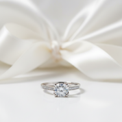 Silver ring with a large diamond on a white satin background